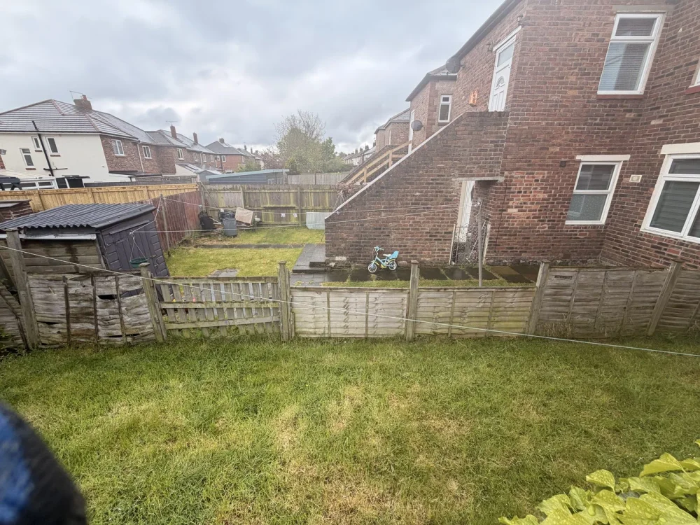 Weathered garden fence panels before replacement by Sharp Hedges